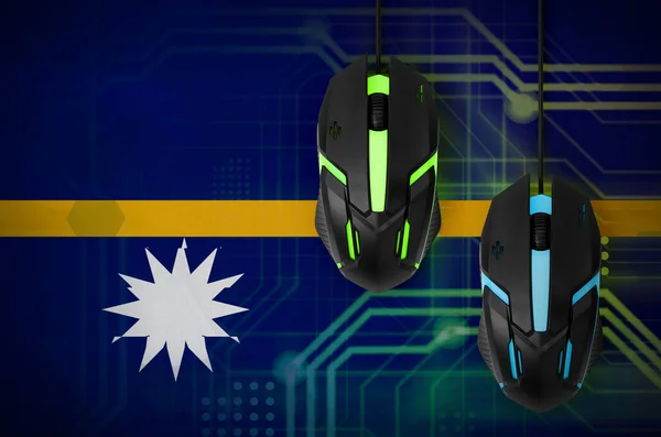 Nauru flag  and two modern computer mice with backlight. The concept of online cooperative games. Cyber sport team