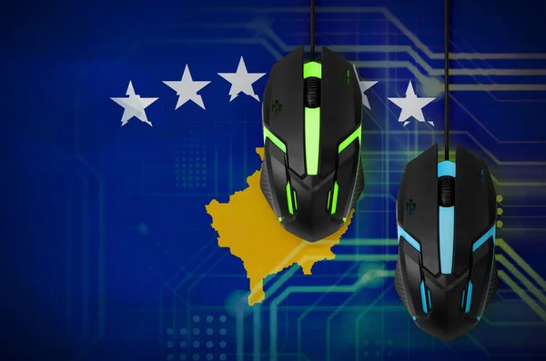 Kosovo flag  and two modern computer mice with backlight. The concept of online cooperative games. Cyber sport team
