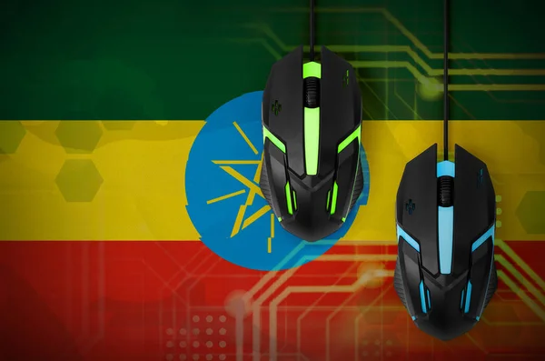 Ethiopia flag  and two modern computer mice with backlight. The concept of online cooperative games. Cyber sport team