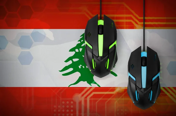 Lebanon flag  and two modern computer mice with backlight. The concept of online cooperative games. Cyber sport team
