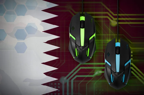 Qatar flag  and two modern computer mice with backlight. The concept of online cooperative games. Cyber sport team