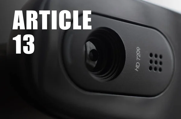 A modern web camera on monitor and article 13 inscription