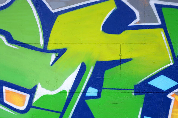 Фрагмент цветных уличных граффити с контурами и затенением крупным планом. Фоновая текстура молодежной культуры современного искусства. Зеленый и желтый цвета
