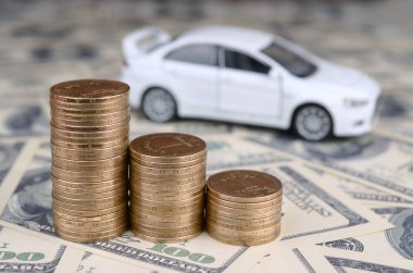 Altın paralar yığınları oyuncak araba modeli birçok dolar banknotlar yatıyor