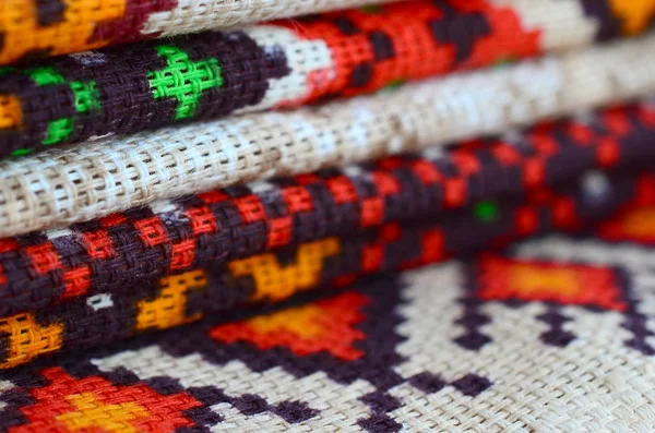 Stack of traditional Ukrainian folk art knitted embroidery patterns on textile fabric