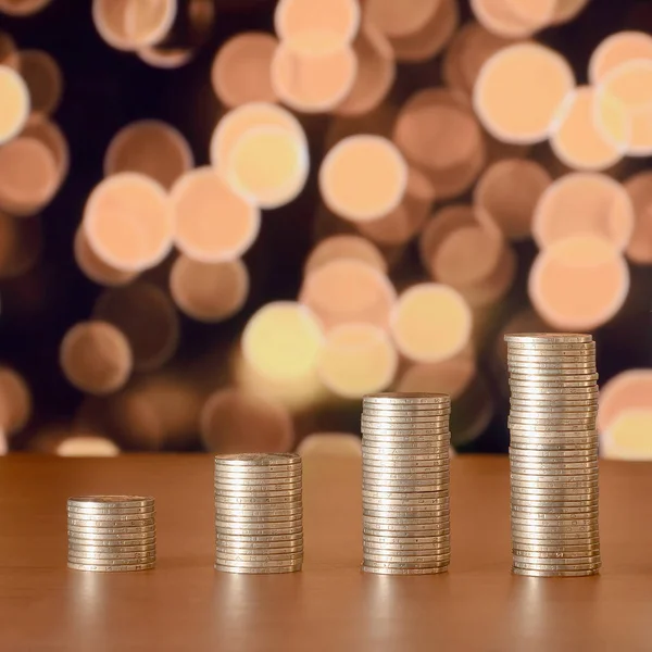 Golden coin stacks arranged as a graph. Increasing columns of coins