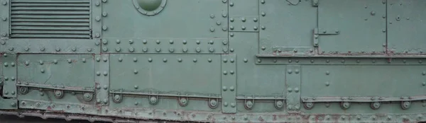 Texture of tank side wall, made of metal and reinforced with a multitude of bolts and rivets — Stock Photo, Image