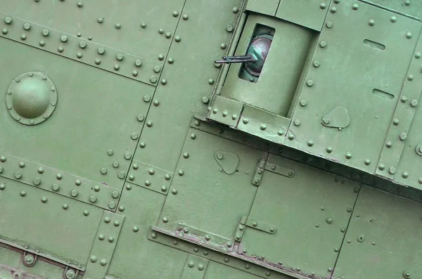 Texture of tank side wall, made of metal and reinforced with a multitude of bolts and rivets — Stock Photo, Image