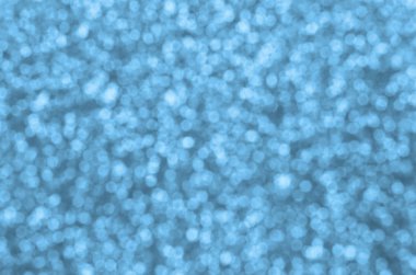 Bulanık mavi dekoratif payetler. Küçük öğelerden parlak bokeh ışıkları ile arka plan görüntüsü