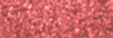 Bulanık mercan kırmızısı dekoratif payetler. Küçük öğelerden parlak bokeh ışıkları ile arka plan görüntüsü