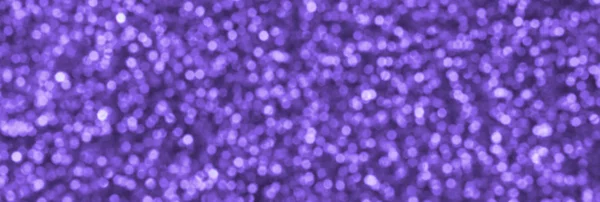 Blurred violet decorative sequins. Background image with shiny bokeh lights from small elements — Stock Photo, Image