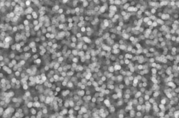 Blurred silver decorative sequins. Background image with shiny bokeh lights from small elements — Stock Photo, Image