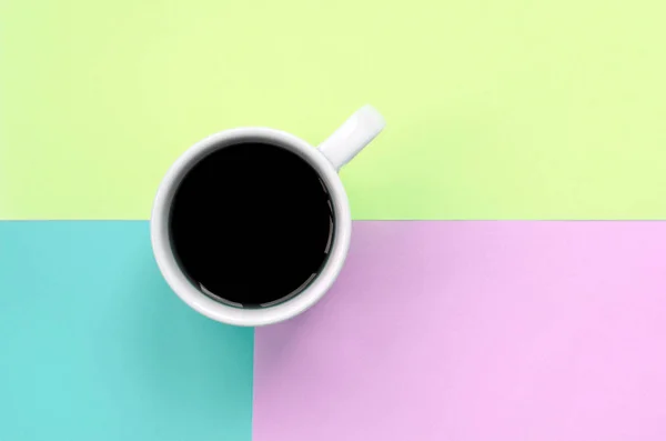 Small white coffee cup on texture background of fashion pastel pink, blue and lime colors paper — Stock Photo, Image