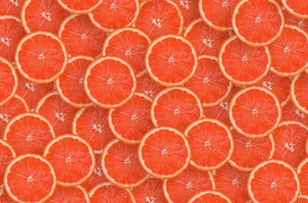 Pattern of red grapefruit citrus slices. Citrus flat lay — Stock Photo, Image