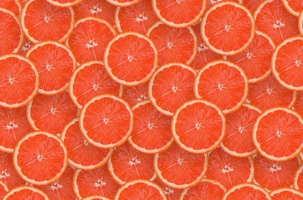 Wzór czerwonych grejpfrutów plasterków cytrusowych. Płaski cytrusowy lay — Zdjęcie stockowe