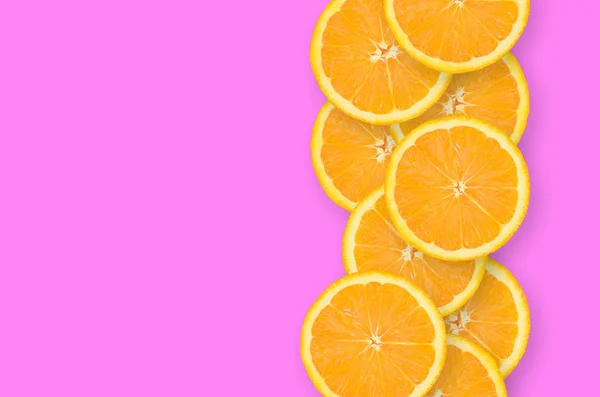 Row of an orange citrus slices on bright purple background — Stock Photo, Image