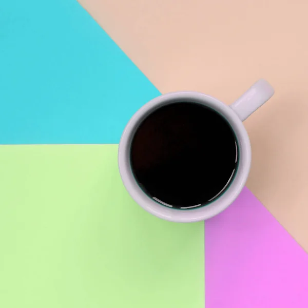 Small white coffee cup on texture background of fashion pastel pink, blue, coral and lime colors paper — Stock Photo, Image