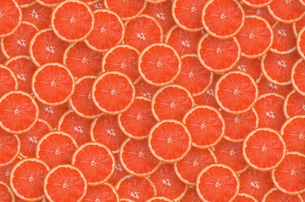 Pattern of red grapefruit citrus slices. Citrus flat lay