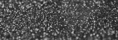 Gümüş dekoratif pullar. Küçük elementlerin parlak bokeh ışıklarıyla arkaplan resmi