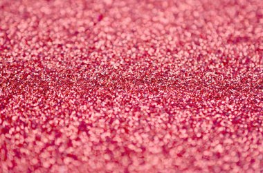 Mercan kırmızısı dekoratif payetler. Küçük öğelerden parlak bokeh ışıkları ile arka plan görüntüsü