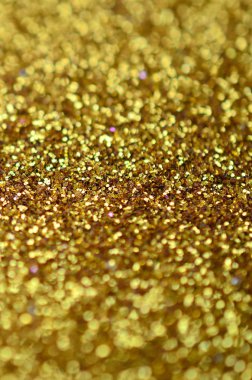 Turuncu dekoratif payetler. Küçük öğelerden parlak bokeh ışıkları ile arka plan görüntüsü