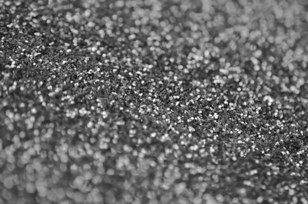 Silver decorative sequins. Background image with shiny bokeh lights from small elements