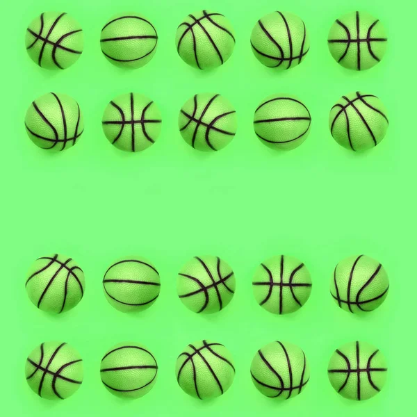 Many small green balls for basketball sport game lies on texture background — Stock Photo, Image