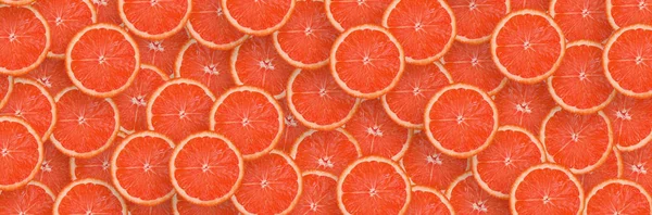 赤グレープフルーツ柑橘類のスライスのパターン。シトラスフラットレイ — ストック写真