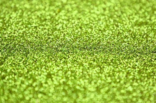 Lime green decorative sequins. Background image with shiny bokeh lights from small elements — Stock Photo, Image