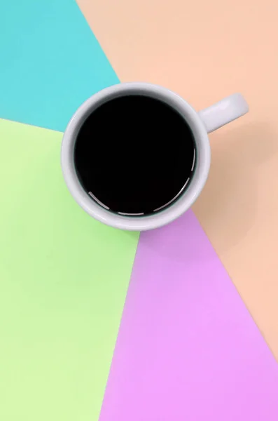 Small white coffee cup on texture background of fashion pastel pink, blue, coral and lime colors paper — Stock Photo, Image