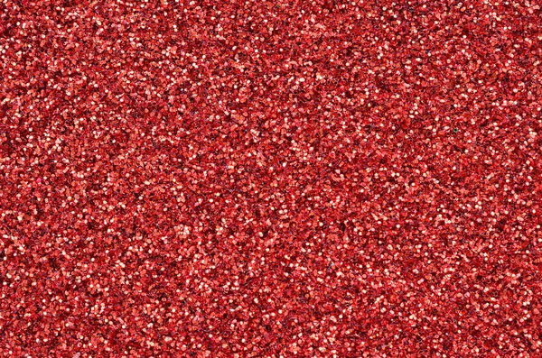 Lantejoulas decorativas vermelhas carmesim. Imagem de fundo com luzes bokeh brilhantes de pequenos elementos — Fotografia de Stock