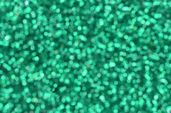 Blurred green decorative blins. Фон изображения с блестящими боке огни из небольших элементов — стоковое фото