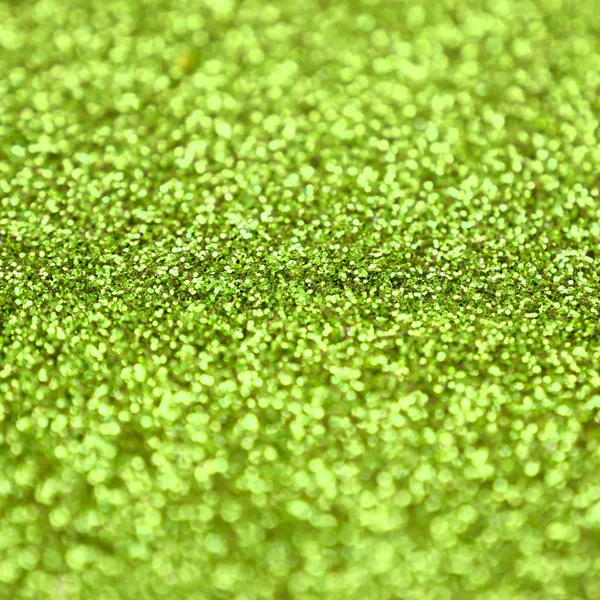 Lime zöld díszítő flitter. Háttérkép fényes bokeh fények kis elemek — Stock Fotó