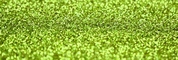 Lime zöld díszítő flitter. Háttérkép fényes bokeh fények kis elemek — Stock Fotó