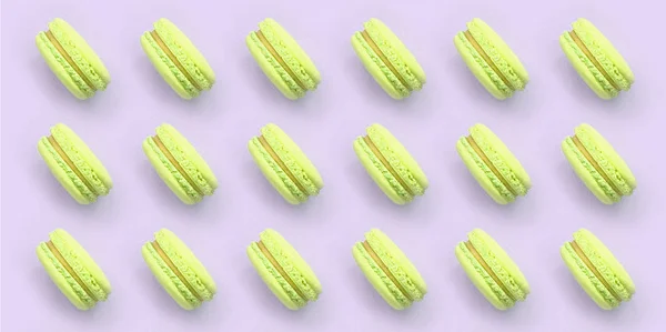 Žlutozelená makaron nebo makaroon na módním pastelově fialový pohled na pozadí — Stock fotografie