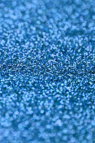 Blue decorative sequins. Background image with shiny bokeh lights from small elements Royalty Free Stock Images
