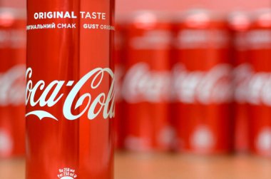 Coca-Cola logosu alüminyum kutulara baskılı ve alışveriş merkezi masasına yerleştirilir