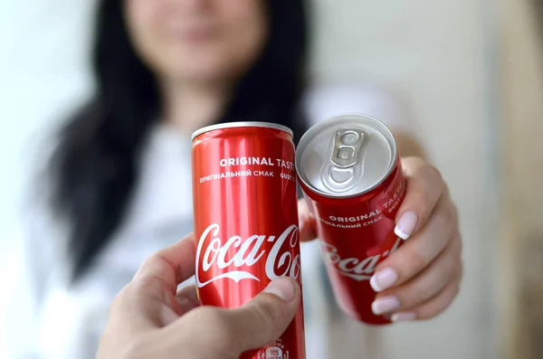 Mulher feliz levantar lata Coca-Cola com amigo masculino na garagem interior — Fotografia de Stock