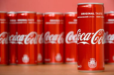 Coca-Cola logosu alüminyum kutulara baskılı ve alışveriş merkezi masasına yerleştirilir
