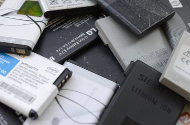 Bir sürü eski kullanılmış cep telefonu pili. Geri dönüşüm elektronik piyasada ucuz satıldı