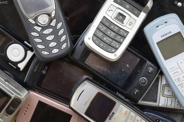 Some old used outdated mobile phones. Recycling electronics in the market cheap