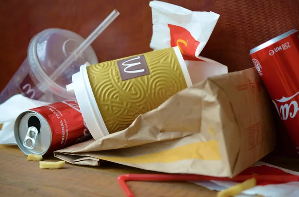 McDonald's garbage or disposable trash on dark brown wooden background — Stock Image McDonald's garbage or disposable trash on dark brown wooden background Stock Image