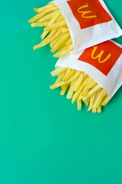 McDonald's French fries in small paperbag on bright green background — Stock Image McDonald's French fries in small paperbag on bright green background Royalty Free Stock Images
