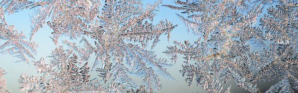 Snowflakes frost rime macro on window glass pane