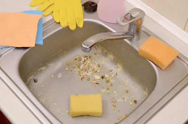 Close up on dirty clogging kitchen sink drain with food particles — Stock Photo, Image