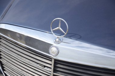 Mersedes Benz logosu eski arabanın ön tarafında. Açık havada.