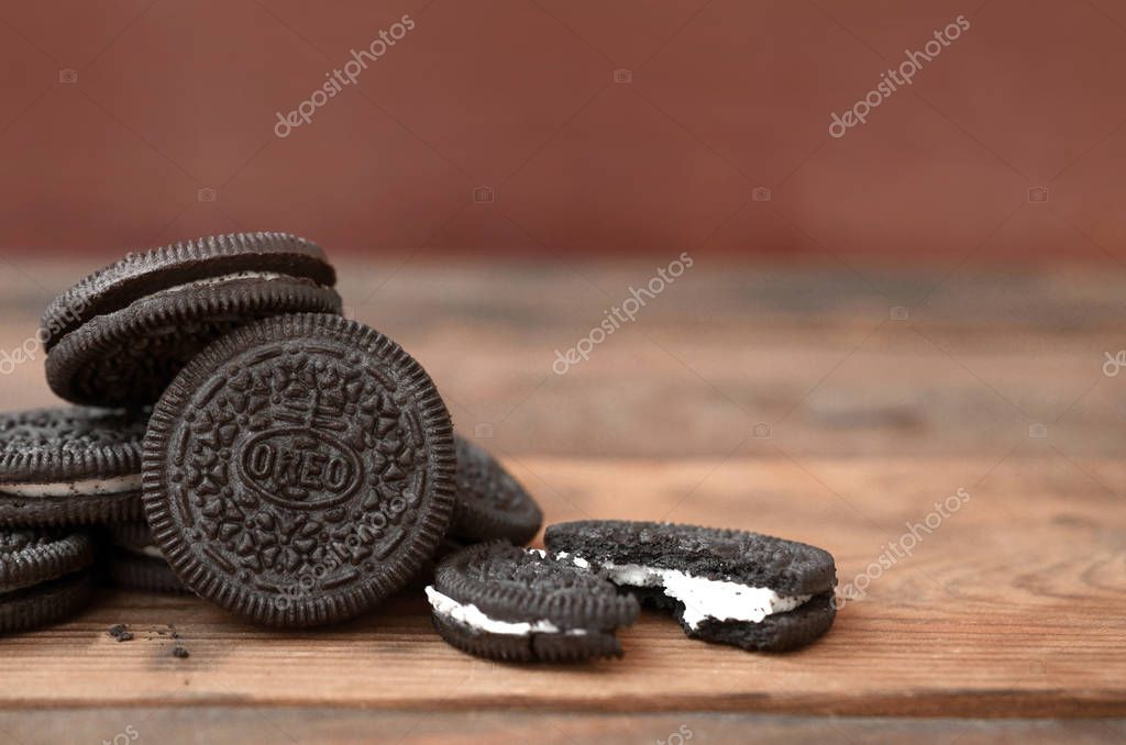 KHARKOV, UKRAINE - SEPTEMBER 8, 2019: Many OREO sandwich cream biscuits on wooden background. Oreo is a sandwich cookie with a sweet cream is the best selling cookie in the US