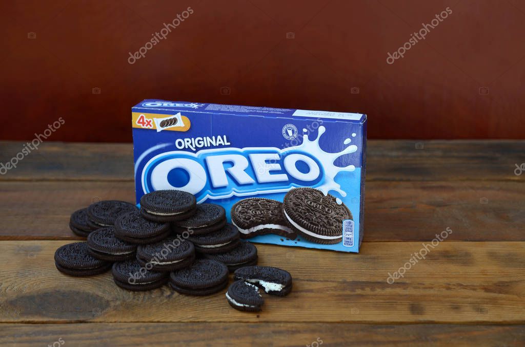 KHARKOV, UKRAINE - SEPTEMBER 8, 2019: Many OREO sandwich cream biscuits with pack on wooden background. Oreo is a sandwich cookie with a sweet cream is the best selling cookie in US