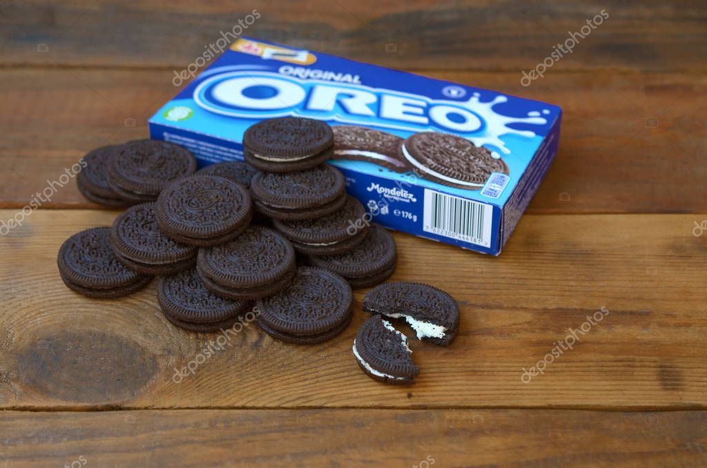 KHARKOV, UKRAINE - SEPTEMBER 8, 2019: Many OREO sandwich cream biscuits with pack on wooden background. Oreo is a sandwich cookie with a sweet cream is the best selling cookie in US