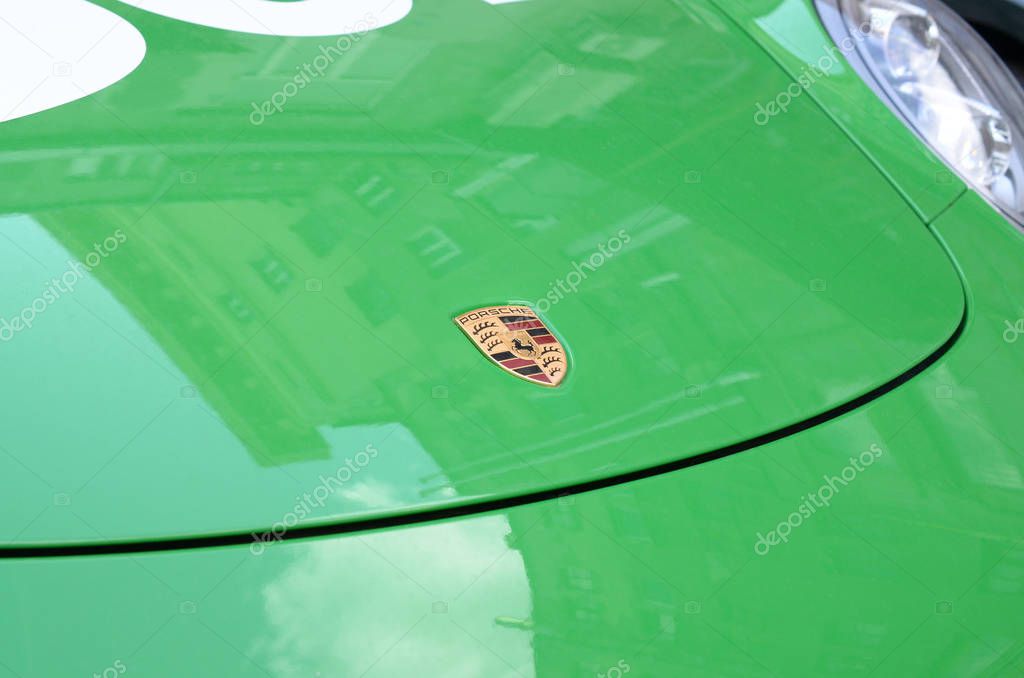 KHARKOV, UKRAINE - SEPTEMBER 24, 2019: Porsche 911 Carrera 4S in green color with frontal main logo close up. Porsche AG is German automobile manufacturer specializing in sports cars SUVs and sedans